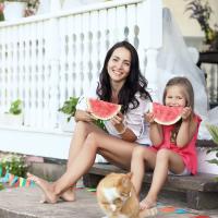mom and daughter outside eating watermelon 